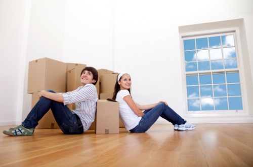 Local moving team organising boxes in a Kilburn property