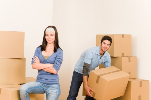 Local movers carrying furniture from a flat in Kilburn