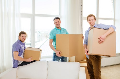 Moving boxes and furniture in a Kilburn flat-share