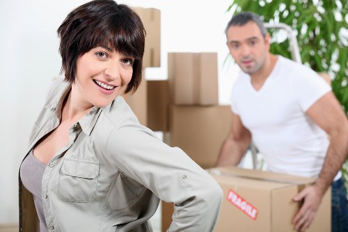 Professional movers handling stairs during a Kilburn flat removal